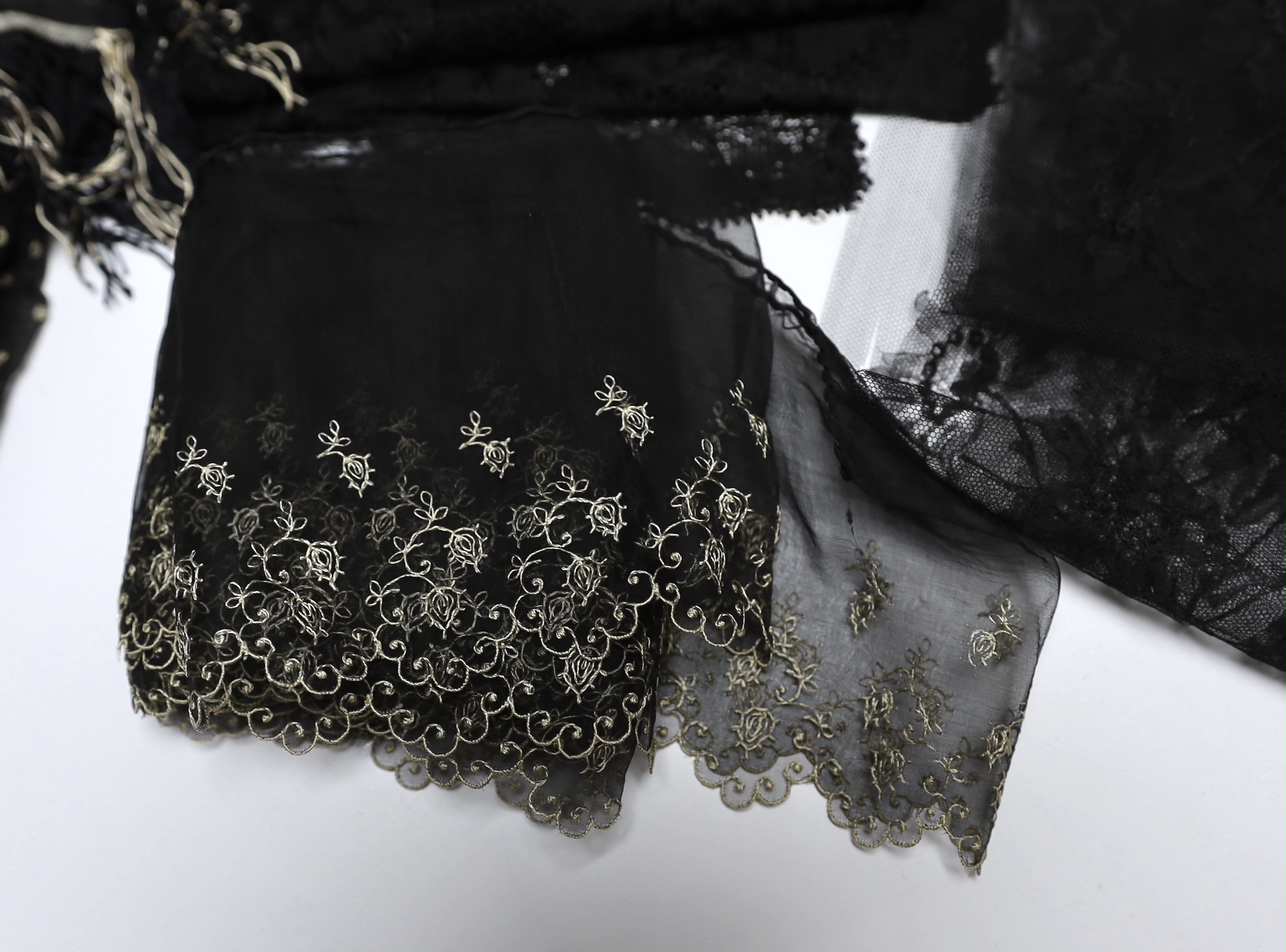 A collection of mostly 19th century French and English needle and bobbin lace trimmings, white worked sleeves, a black silk stole and black lace trimmings etc